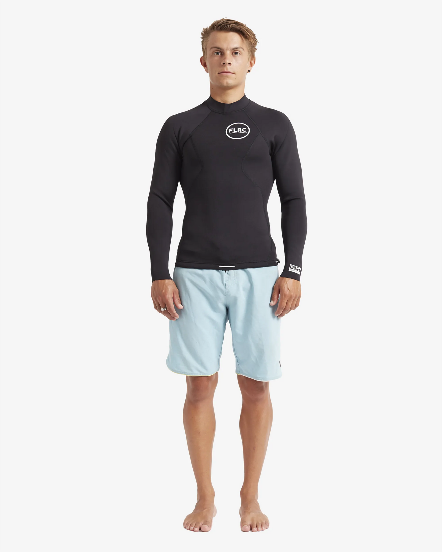 Man wearing black FLRC 1.5mm wetsuit top with white logo, front view in studio.