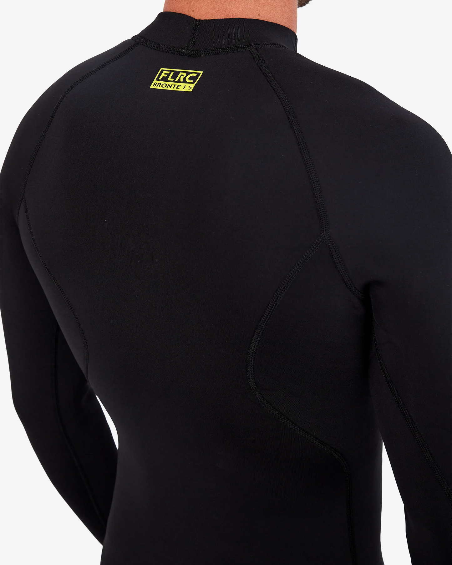 Close-up of black FLRC 1.5mm wetsuit top with yellow logo, showing back detail.