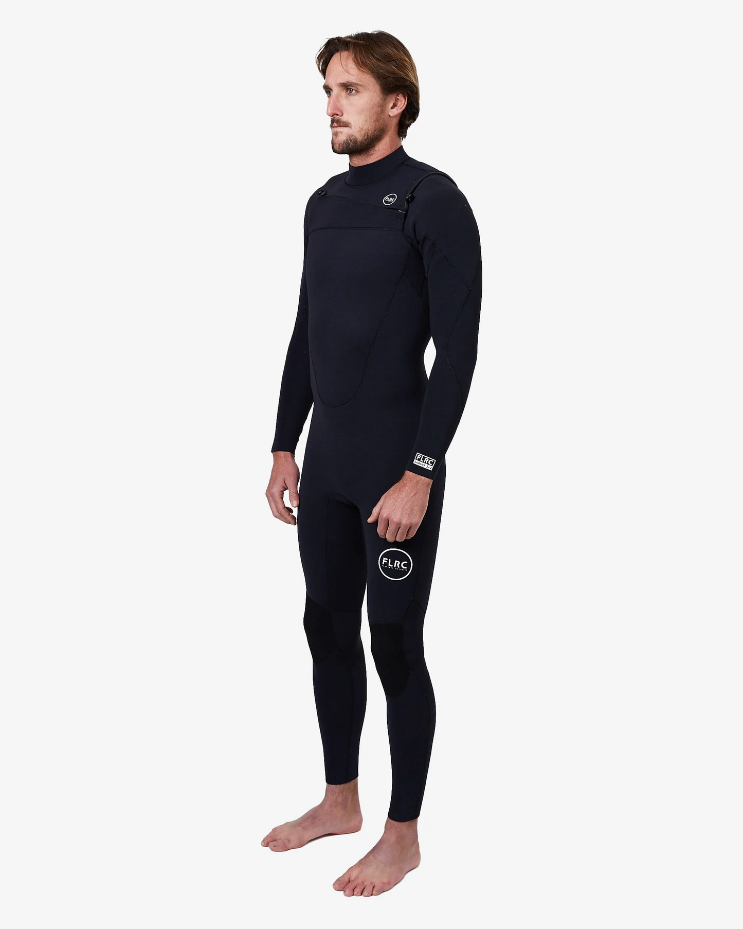 Man wearing black FLRC 3/2mm steamer wetsuit with white logo, angled view in studio.