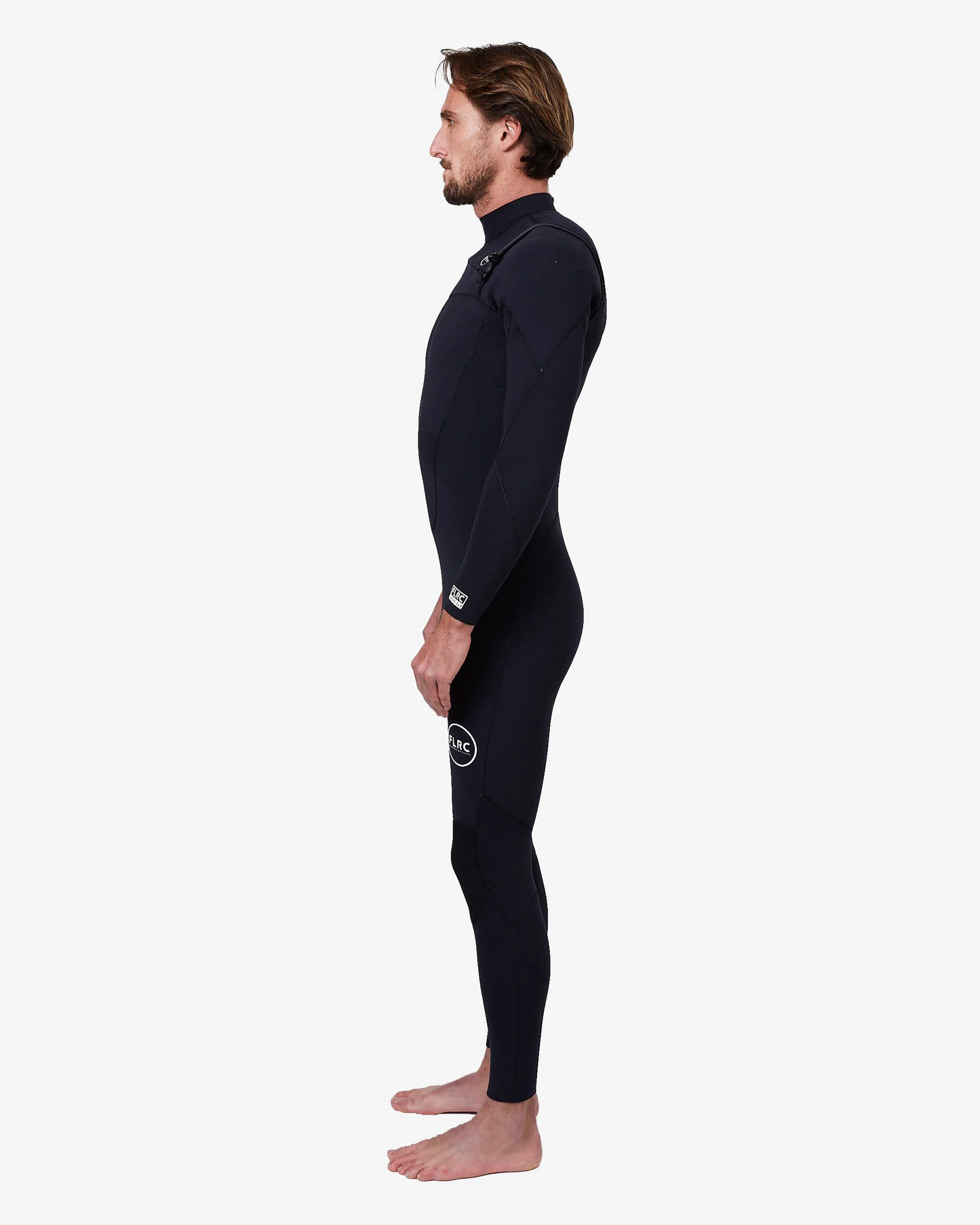 Man wearing black FLRC 3/2mm steamer wetsuit with white logo, side view in studio.
