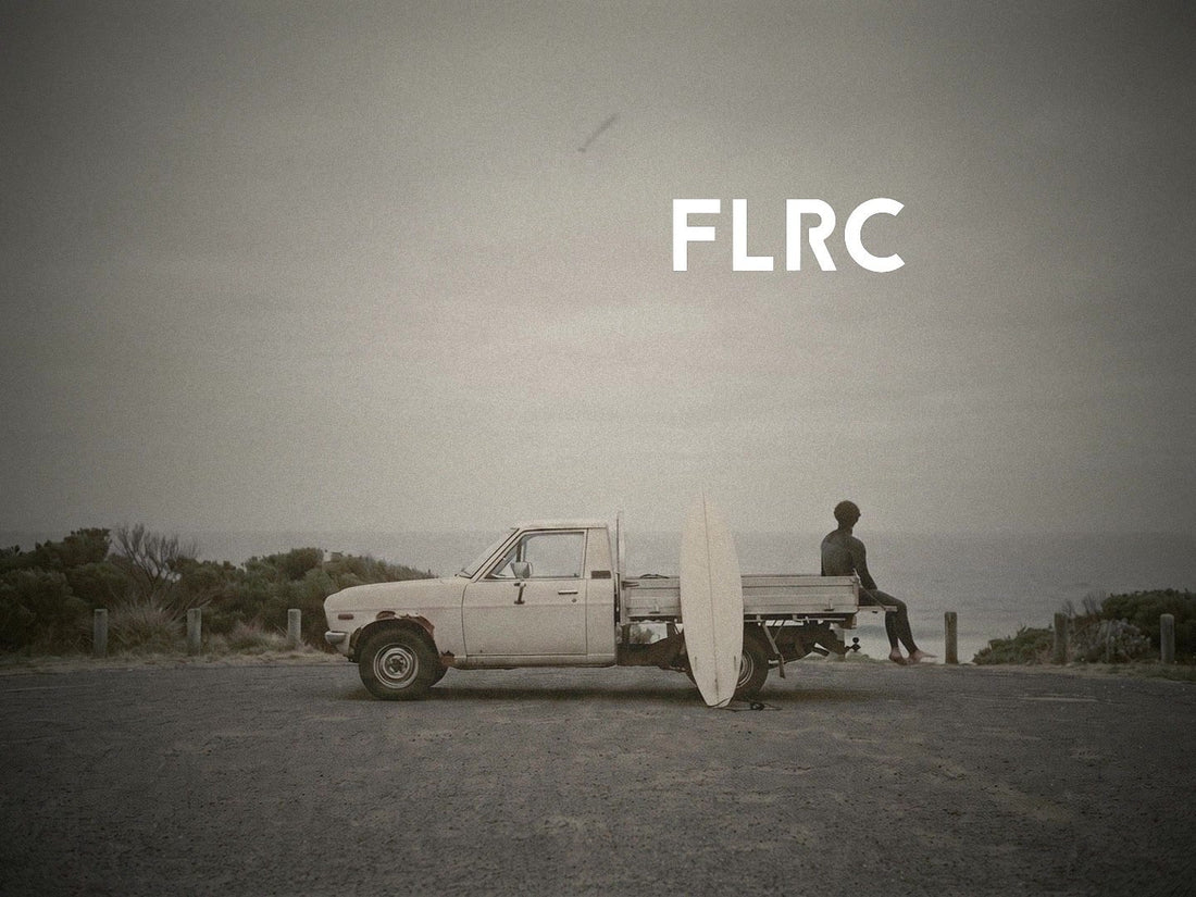 Surfer sitting in the Flatrock Surf Sarvo Series III wetsuit in a beach car park