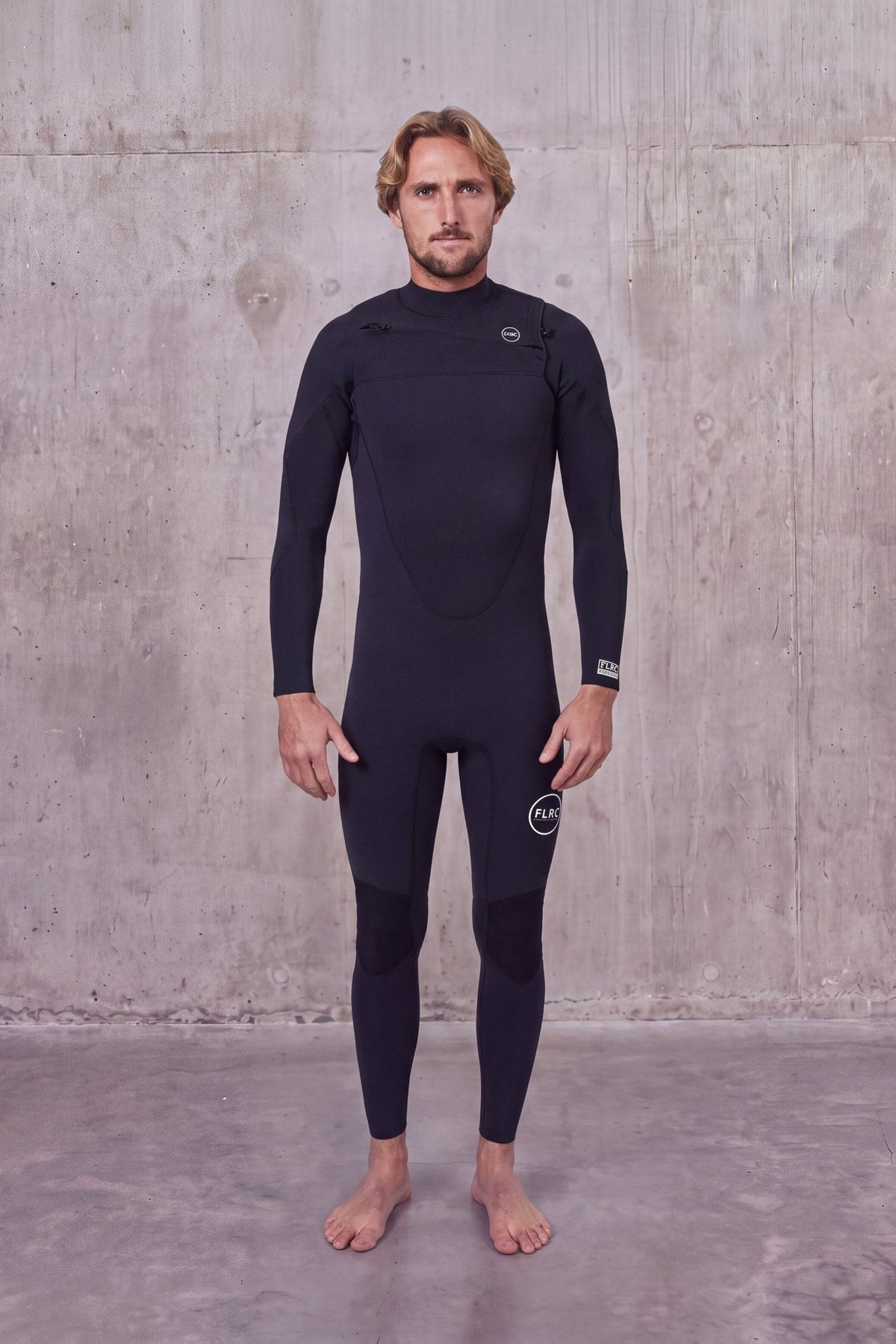 Man in Men's 3/2mm Fullsuit V2 wetsuit, front view with FLRC circle logo on the thigh