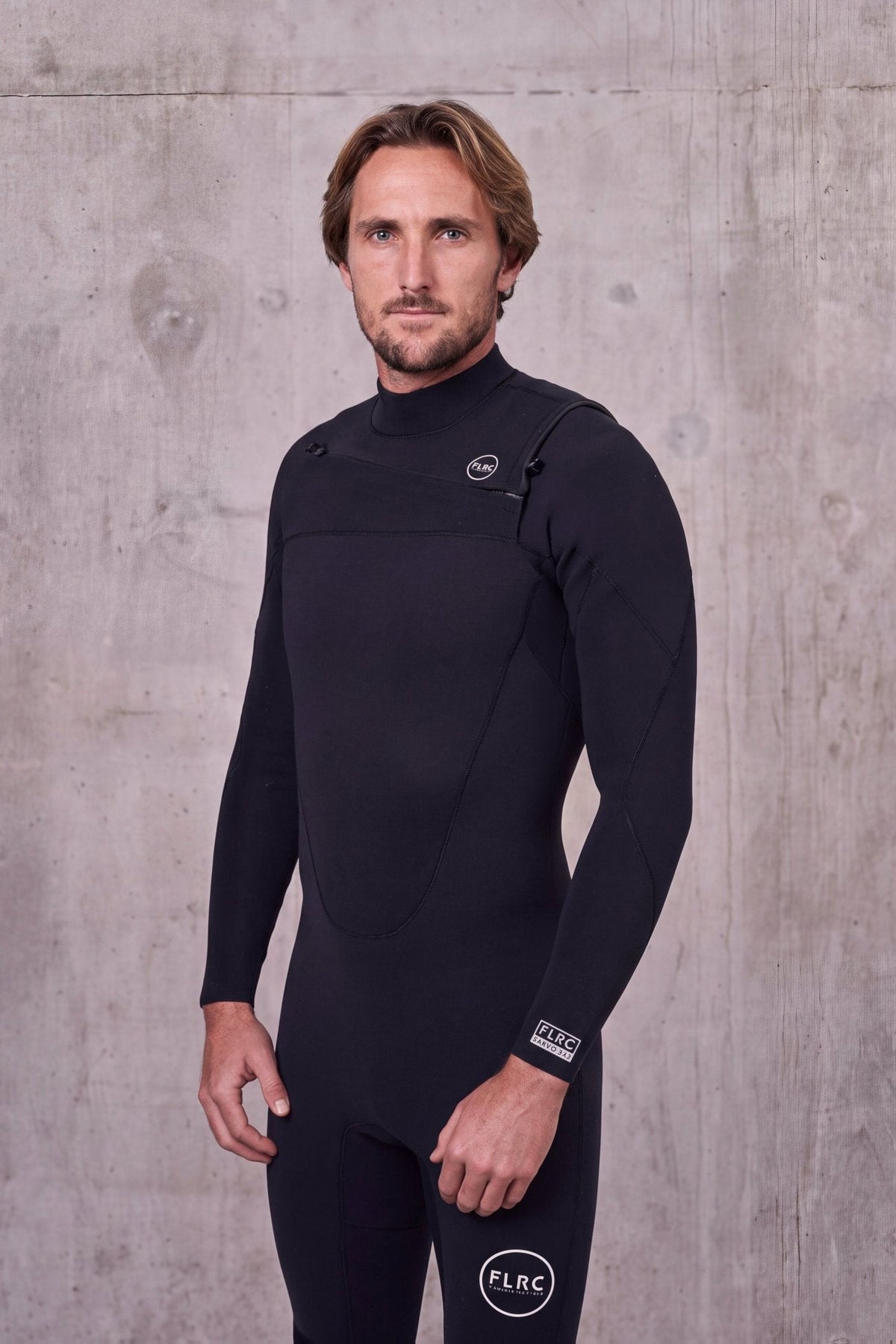 Close three-quarter view of a man in the Men's 3/2mm Fullsuit V2 showing the chest panel and zip