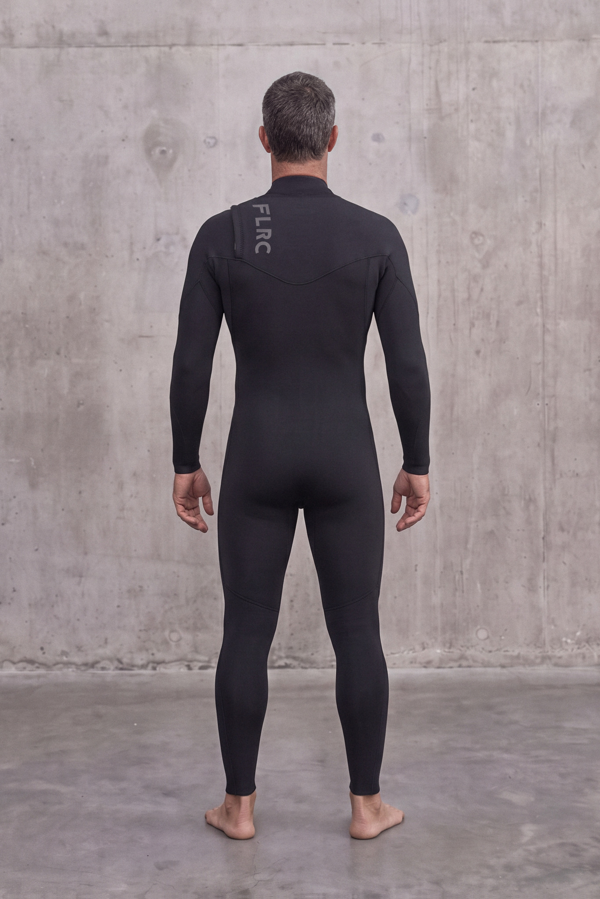 Back view of a man in the Men's 3/2mm Fullsuit V3 wetsuit with FLRC logo at the upper back