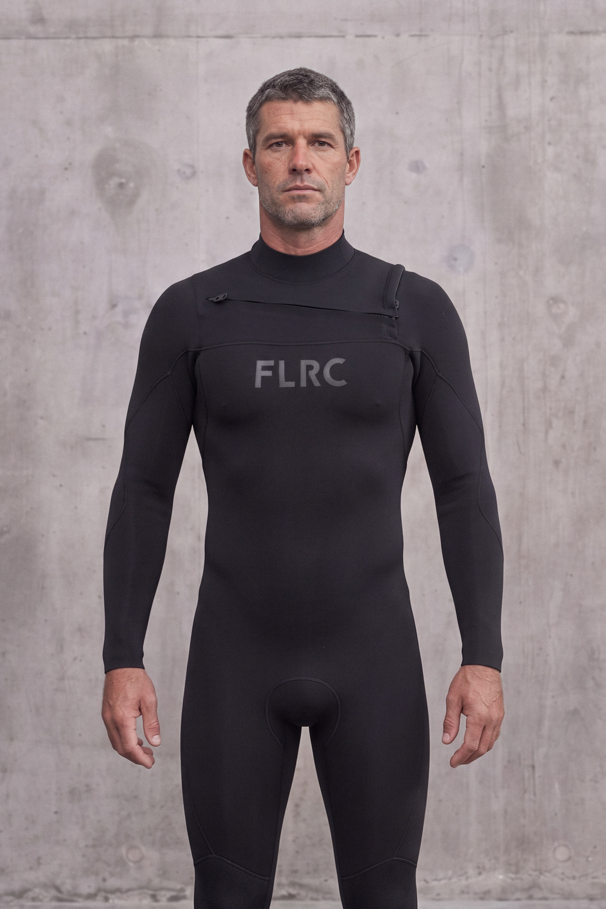 Close portrait of a man in the Men's 3/2mm Fullsuit V3 showing the grey FLRC logo and chest zip