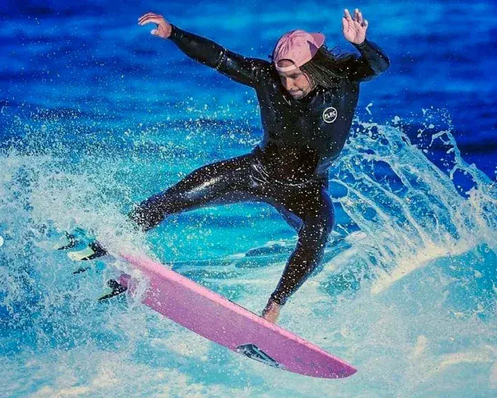 Surfer turning off the top of a wave in the Sarvo fullsuit